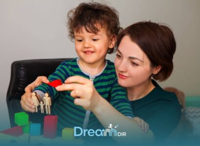 Therapist and autistic child playing with colorful blocks and shapes together, showing supportive learning and interaction at home