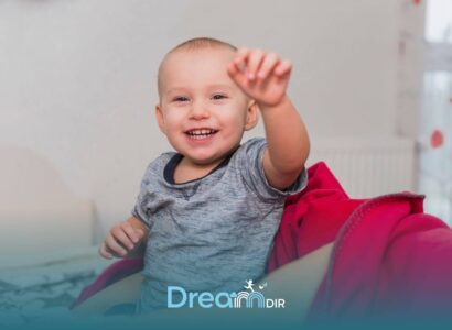 Autistic baby reaching forward while sitting on therapists lap, showing early social and developmental interaction cues