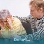 Autistic girl showing emotional distress while another person offers comfort, illustrating support during