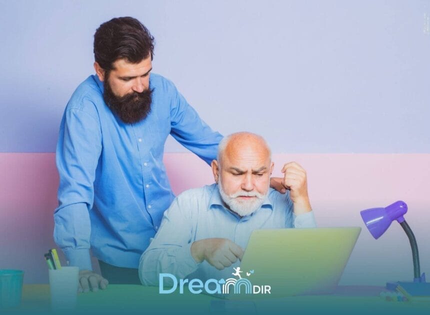 Therapist assisting autistic old man at laptop, pointing at screen while offering guidance and support