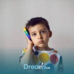Autistic child holding a colorful toy phone to their ear, illustrating communication challenges & selective mutism in autism