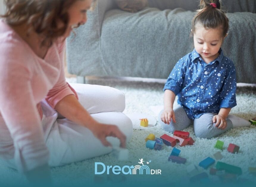 Therapist sitting with an autistic child on a carpet, encouraging play with colorful blocks to support focus