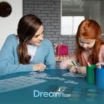Therapist building rapport with an autistic child through creative drawing, educational games, and play-based interaction