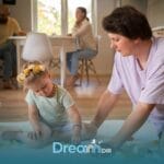 Therapist guiding an autistic girl during floortime therapy with small toys on the floor in New Jersey