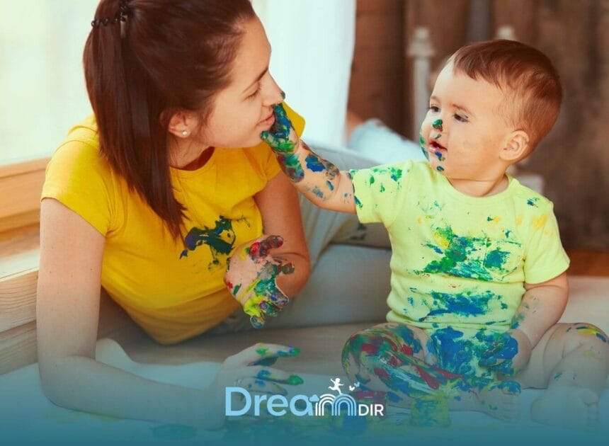 Therapist  & autistic boy engaged in messy sensory painting activity, building connection and creativity