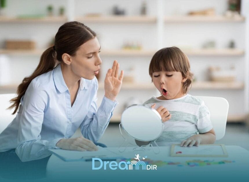 Speech therapist helps an autistic young boy practice mouth sounds and pronunciation using a mirror during a therapy session