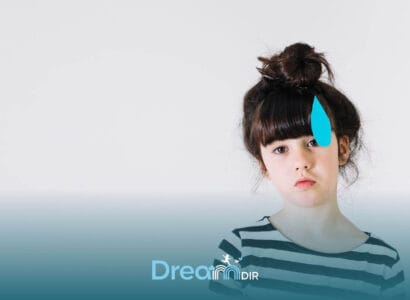 Autistic young girl with a thoughtful expression stands against a plain background with a blue masking symbol beside her face